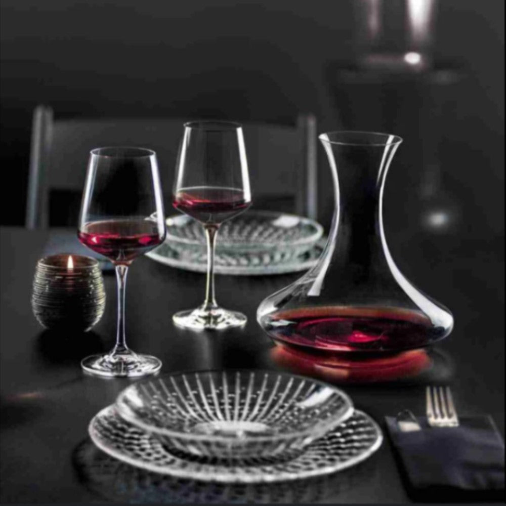 Сет ARIA RCR Italy - две кристални чаши за вино и декантер, поставени върху декорирана елегантна трапеза в черно със кристален сервиз от чинии в луксозна обстановка